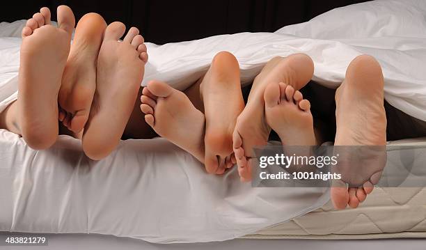 swingers - woman lying on stomach with feet up stock pictures, royalty-free photos & images