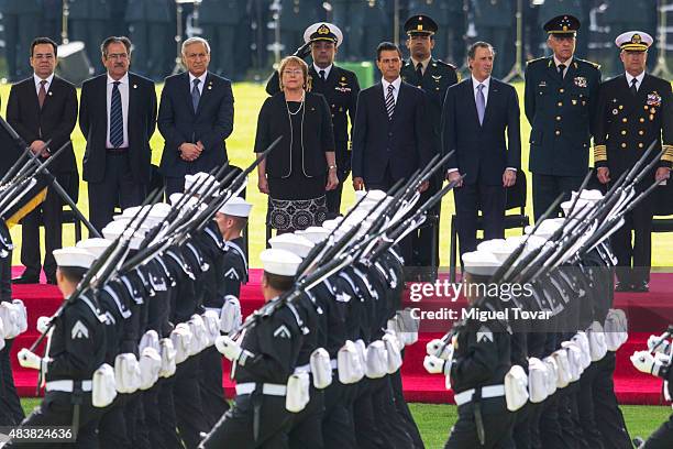 Mexican President Enrique Peña Nieto and Michelle Bachelet, President of Chile, attend a military exhibition during the welcome ceremony as part of...