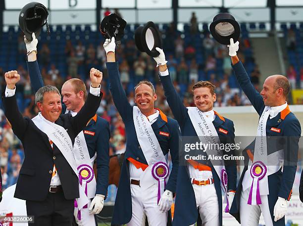 Team leader Wim Ernes, Diederik van Silfhout, Patrick van der Meer, Edward Gal, and Hans Peter Minderhoud of the Netherlands celebrate after winning...