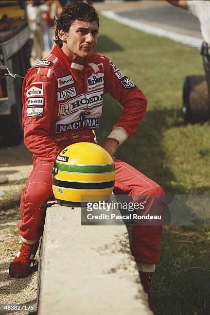 Ayrton Senna of Brazil, driver of the Honda Marlboro McLaren McLaren MP4/5B Honda RA109E V10 sits on a wall after retiring during the Spanish Grand...