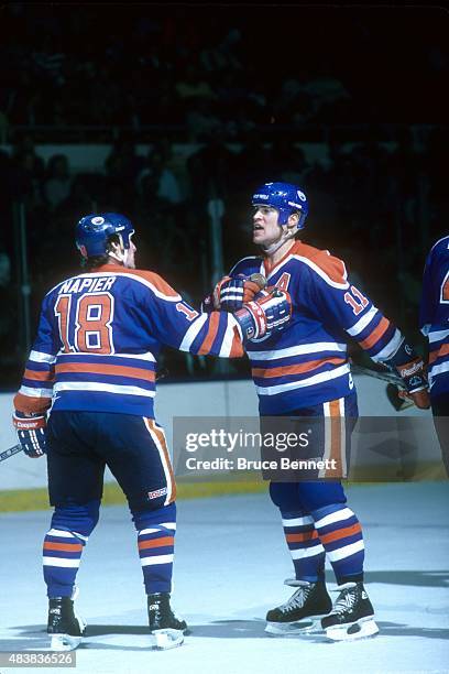 Mark Messier of the Edmonton Oilers yells on the ice as his teammate Mark Napier holds him back during an NHL game against the New York Islanders on...