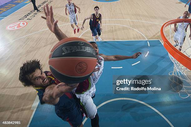 Victor Sada, #8 of FC Barcelona competes with Ilimane Diop, #12 of Laboral Kutxa Vitoria during the 2013-2014 Turkish Airlines Euroleague Top 16 Date...