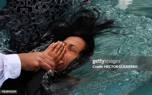 Woman member of the Light of the World church is immersed in water for the celebration of baptism in Guadalajara City, on August 13 within the...