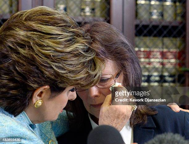 Linda Ridgeway Whitedeer, one of three women accusing comedian Bill Cosby with alleged sexual assault , is comforted by attorney Gloria Allred during...