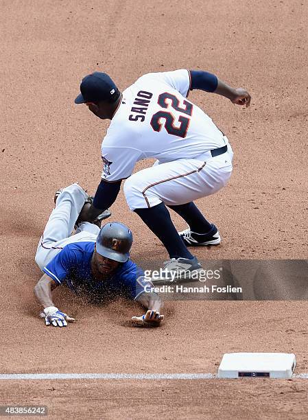 Delino DeShields of the Texas Rangers is out at third base as Miguel Sano of the Minnesota Twins applies the tag during the seventh inning of the...