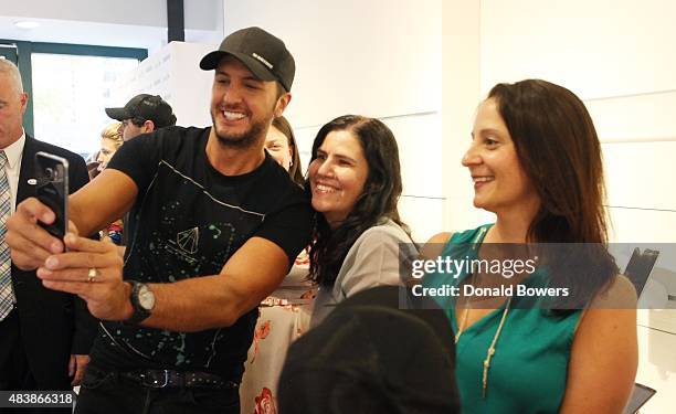 Luke Bryan takes a selfie with fans using the new Galaxy S6 edge+ at the Sprint near Bryant Park in New York to celebrate the unveiling of Samsungs...