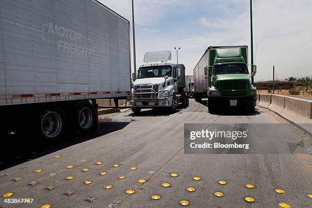 Trucks wait to enter from Mexico at the Calexico East Port of Entry in Calexico, California, U.S., on Wednesday, April 9, 2014. Wholesale trade rose...