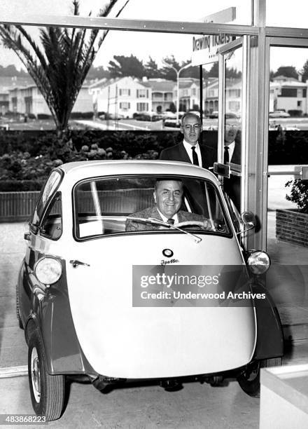 Man in a 1955 BMW Isetta 250, 1955.