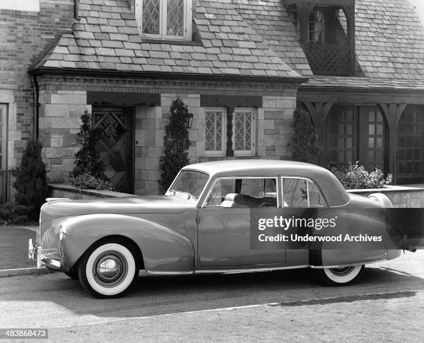 Lincoln Continental parked in front of a home, Detroit, Michigan, 1941.