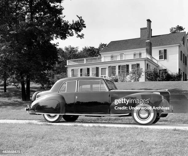 Lincoln Continental parked in front of a home, Detroit, Michigan, 1941.