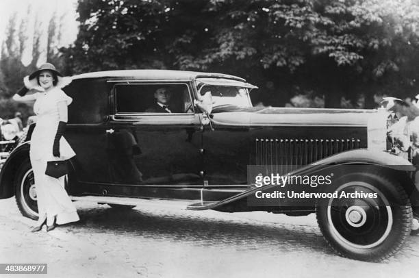 MMe Coste, wife of Dieudonne Coste, noted French aviator, with her entry in the recent International Auto Show, Paris, France, late 1920s.
