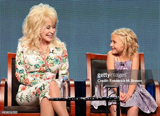 Executive producer Dolly Parton and actress Alyvia Alyn Lind speak onstage during NBC's 'Dolly Parton's Coat of Many Colors' panel discussion at the...