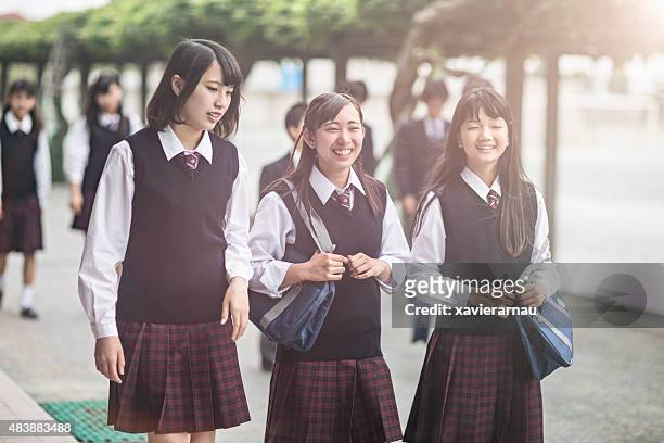 japanese students walking outside the school yard - japan 12 years girl stock pictures, royalty-free photos & images