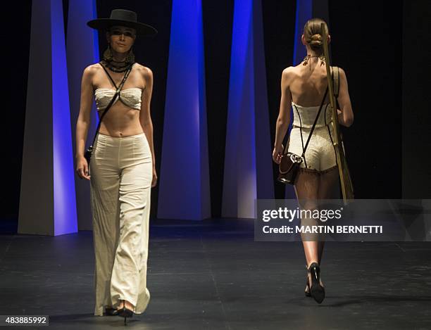 Models present creations by Lupe Gajardo during the 2015 spring-summer collection of the Mercedes Benz Fashion Week in Santiago, Chile, on August 13,...