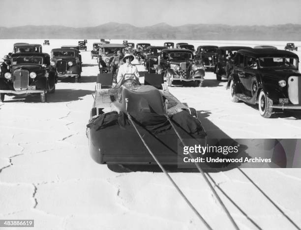 Sir Malcolm Campbell's Bluebird race car is towed out to the salt beds for its first test run in his attempt to set a new automobile speed record of...