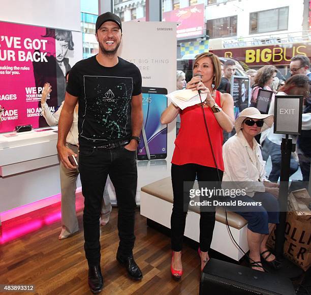 Luke Bryan takes a selfie with fans using the new Galaxy S6 edge+ at the T-Mobile Times Square store in New York to celebrate the unveiling of...
