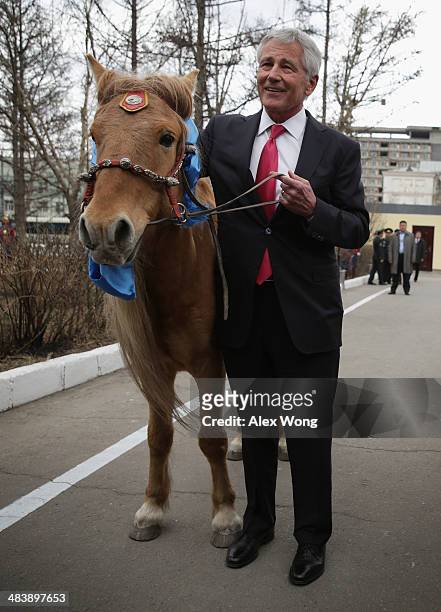 Secretary of Defense Chuck Hagel is presented with a horse as a gift by Mongolian Defense Minister Dashdemberal Bat-Erdene at the Mongolian Ministry...