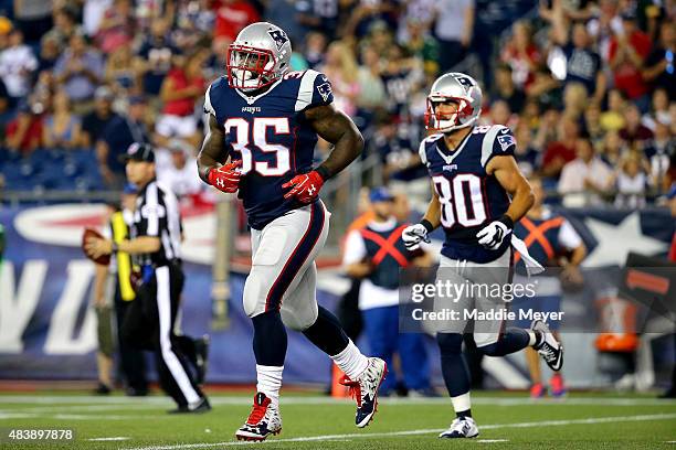 Jonas Gray of the New England Patriots runs off the field after a touchdown in the second quarter against the Green Bay Packers during a preseason...