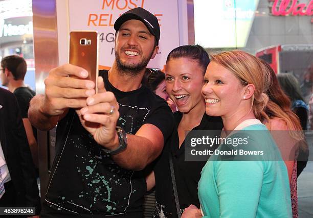 Luke Bryan takes a selfie with fans using the new Galaxy S6 edge+ at the AT&T store in New York to celebrate the unveiling of Samsungs newest...