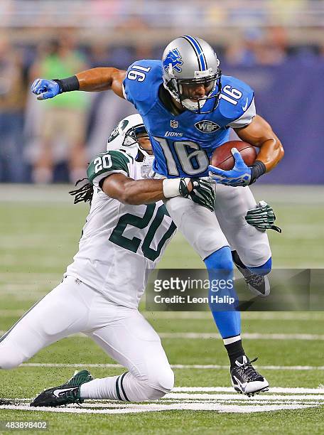 Lance Moore of the Detroit Lions runs for a short gain as Marcus Williams of the New York Jets makes the stop during the first quarter of the...