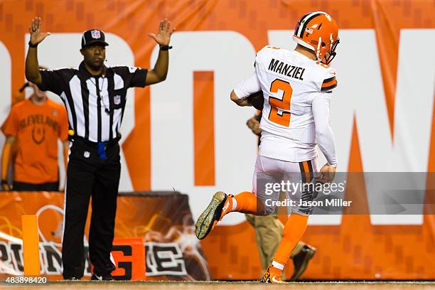 Quarterback Johnny Manziel of the Cleveland Browns runs in a touchdown during the first half against the Washington Redskins at FirstEnergy Stadium...