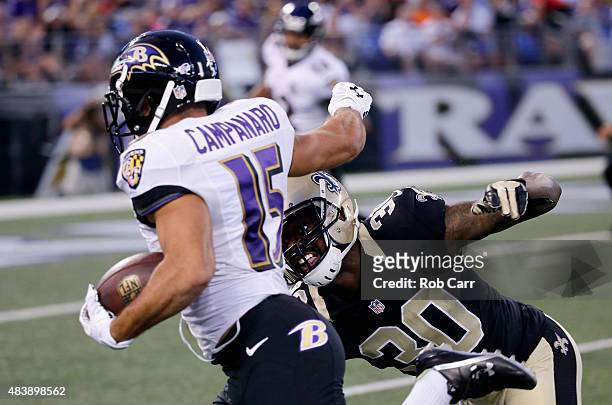 Michael Campanaro of the Baltimore Ravens eludes the tackle of Kenny Phillips of the New Orleans Saints for a first half touchdown during a preseason...
