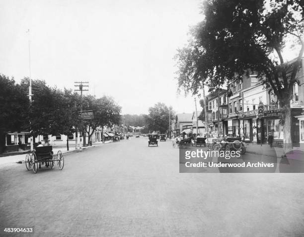 Horses and buggies and automobiles share Main Street, Huntington, Long Island, New York, early 1910s.