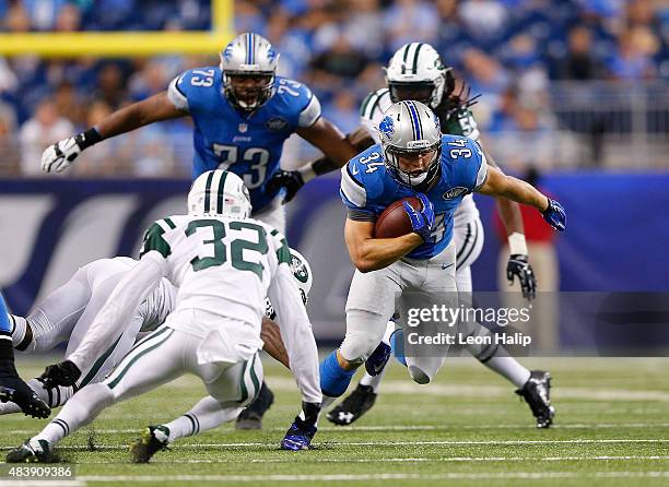 Defensive back Nate Ness of the Detroit Lions runs for a first down as Dashaun Phillips of the New York Jets gets ready to make the stop during the...