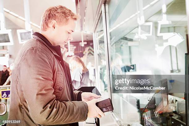london commuter buying overground tickets - bank teller stock pictures, royalty-free photos & images