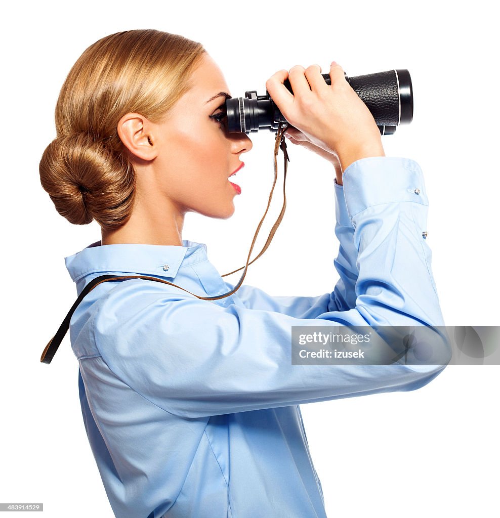 Businesswoman with binoculars