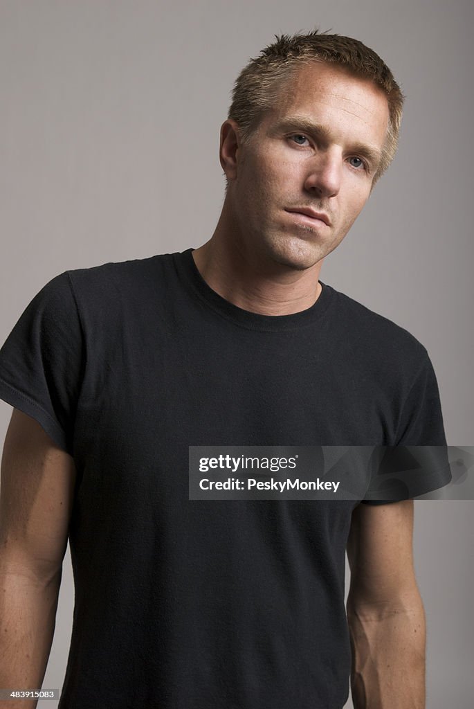 Young Man in Black T-Shirt Looks at Camera Bad Attitude