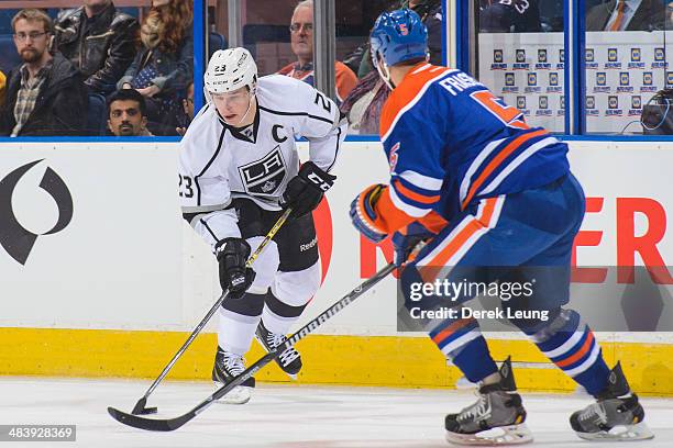 Mark Fraser of the Edmonton Oilers defends against Dustin Brown of the Los Angeles Kings during an NHL game at Rexall Place on April 10, 2014 in...