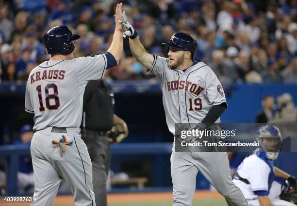 Robbie Grossman of the Houston Astros is congratulated by Marc Krauss after hitting a two-run home run in the fifth inning during MLB game action...