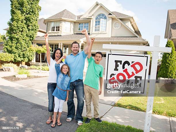 family with "for sale, sold" real estate sign - real estate sign stock pictures, royalty-free photos & images