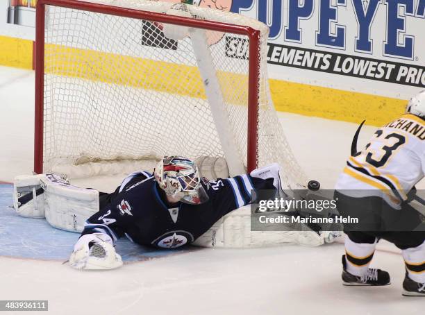 Michael Hutchinson of the Winnipeg Jets blocks a shot from Brad Marchand of the Boston Bruins in shootout action in an NHL game at the MTS Centre on...