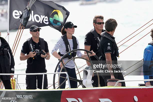 Catherine, Duchess of Cambridge helms an America's Cup yacht as she races Prince William, Duke of Cambridge in Auckland Harbour on April 11, 2014 in...