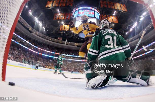 Seth Ambroz of the Minnesota Golden Gophers celebrates teammate Justin Holl's goal with .6 seconds left in the game as goaltender Zane Gothberg of...