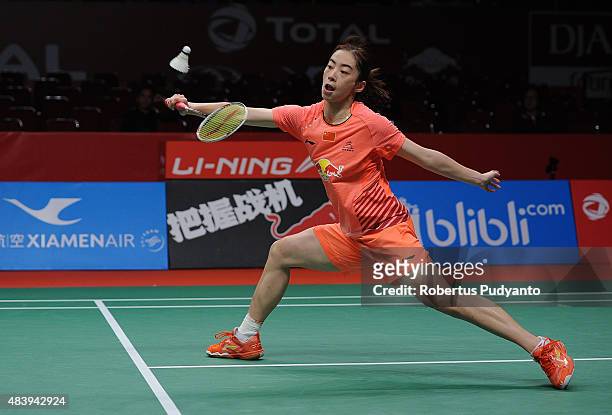 Wang Shixian of China competes against Carolina Marin of Spain in the quarter finals match of the 2015 Total BWF World Championship at Istora Senayan...