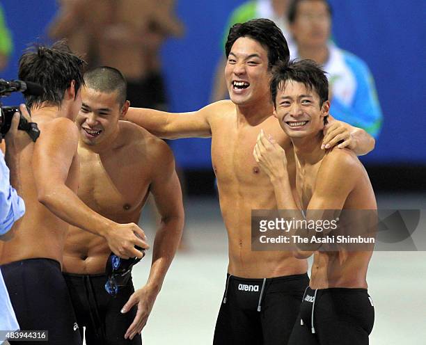 Takuro Fujii, Ranmaru Harada, Ryo Tateishi and Ryosuke Irie of Japan celebrate winning the gold medal in the Men's 400m Medley Relay during day six...