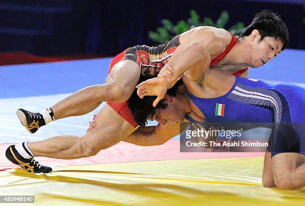 Tatsuhiro Yonemitsu of Japan and Mehdi Taghavi of Iran compete in the Wrestling Men's Freestyle -66kg final during day twelve of the Guangzhou Asian...