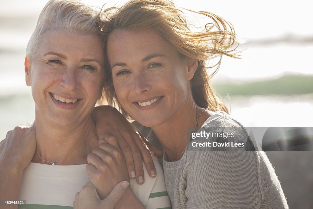 Close up of mother and daughter on beach