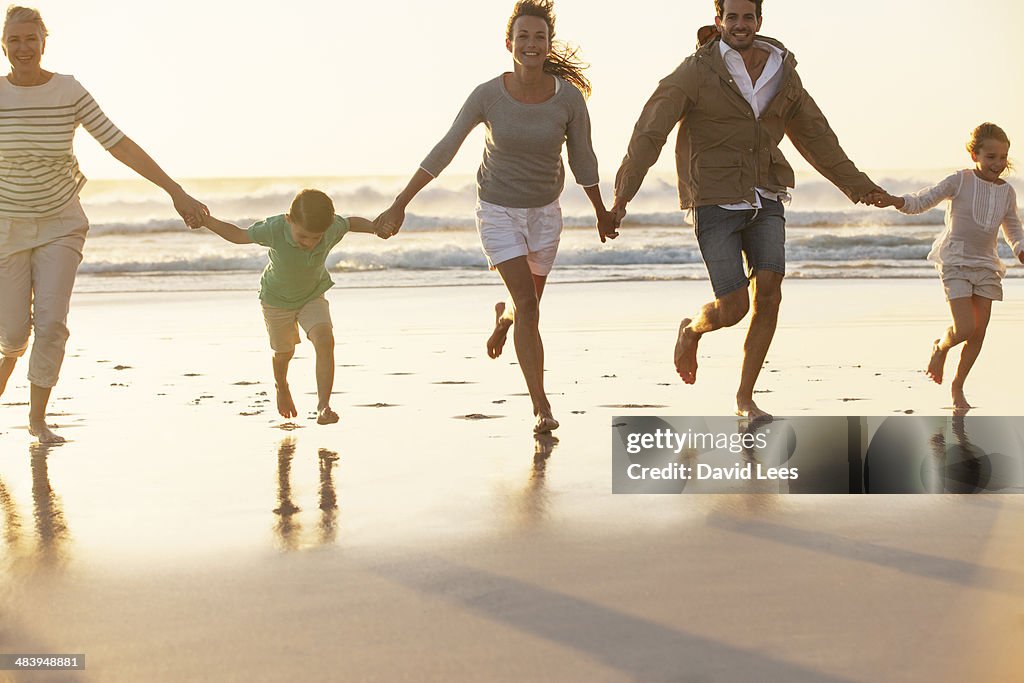 Family holding hands on beach