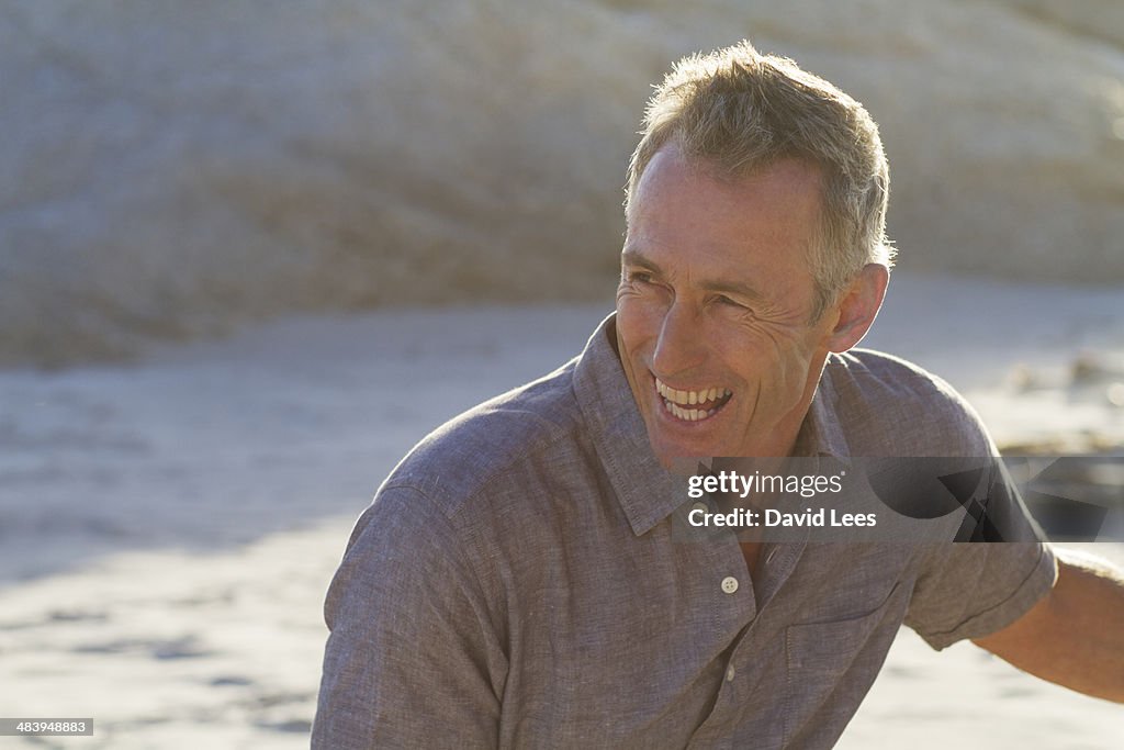 Close up of smiling mature man on beach