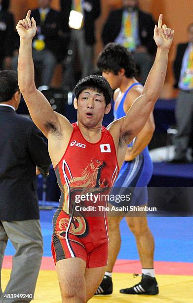 Tatsuhiro Yonemitsu of Japan celebrates winning the gold medal after the Wrestling Men's Freestyle -66kg final against Mehdi Taghavi during day...