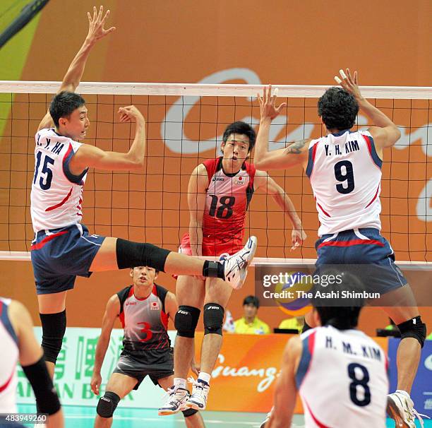 Yuta Yoneyama of Japan spikes the ball during the Men's Volleyball semi final match between South Korea and Japan during day twelve of the Guangzhou...