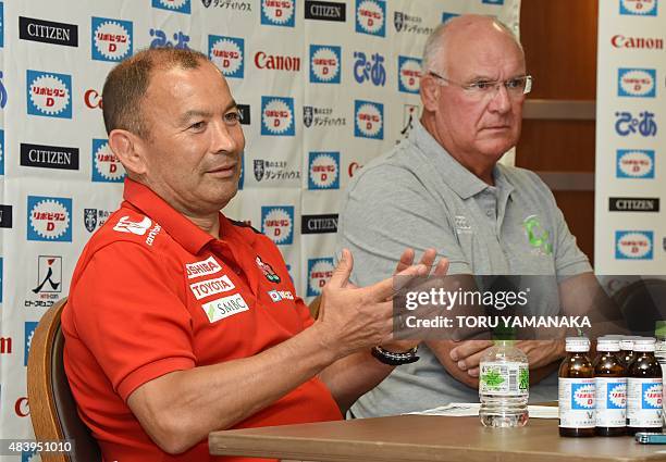 Head coach of Japanese national team Eddie Jones gestures as he answers questions beside assistant coach of World XV Andy Haden during their press...