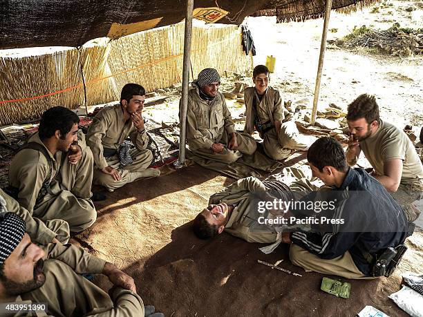 Volunteer members eat together during training. They joined as volunteers with PDK-I in the north of Iran at the border of Iraq-Iran Peshmerga. The...