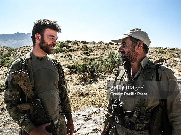 Ryan O'leary , a 28 years old American volunteer member of PDKI talks with his colleague. He joined as volunteer with PDK-I in the north of Iran at...