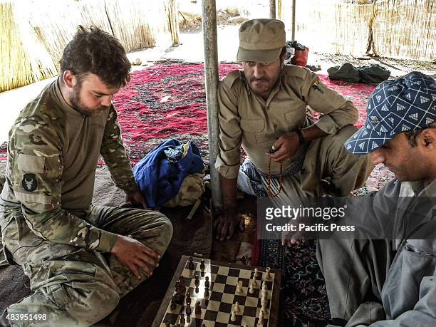 Ryan O'leary , a 28 year old American volunteer member of PDKI plays chess with his colleague. He joined as volunteer with PDK-I in the north of Iran...