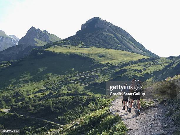 Hikers in the Karwendel mountain walk towards the Eng valley on August 9, 2015 near Eng Alm, Austria. The Karwendel mountain range, part of the...